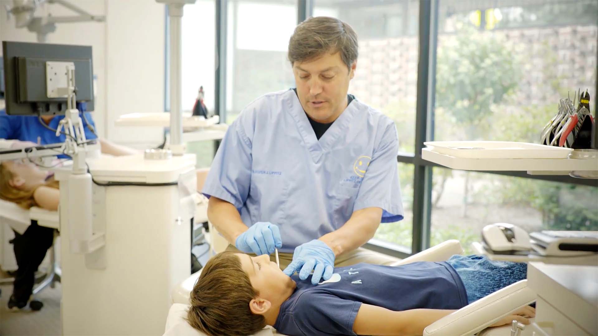 Doctor Lippitz examines a young patient at Lippitz Orthodontics