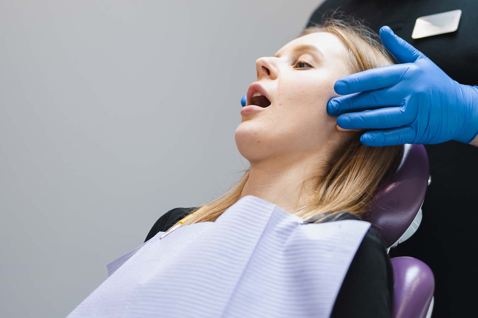 Orthodontist examines his patient's jaw