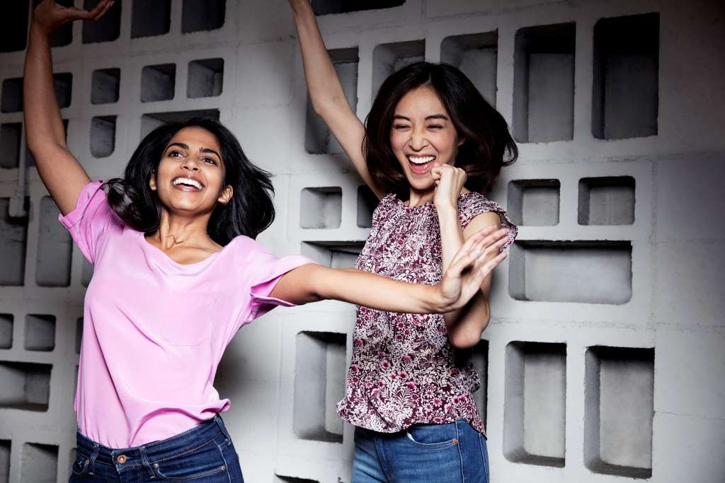  Two-women-wearing-Invisalign-clear-aligners-and-jumping-for-joy
