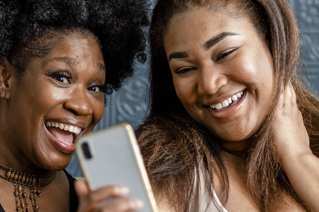 Two women in Wheeling smiling for a selfie. One woman has crooked teeth.