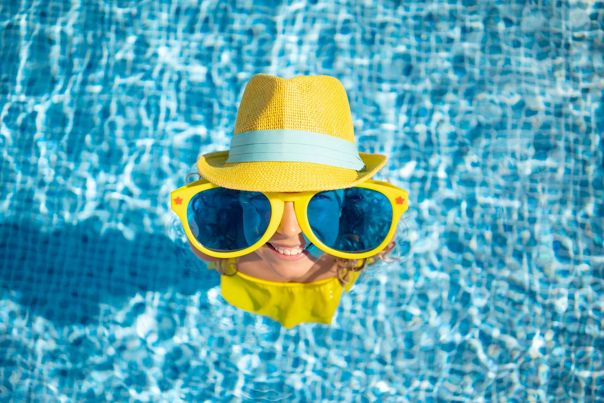 happy child enjoying summer in swimming pool