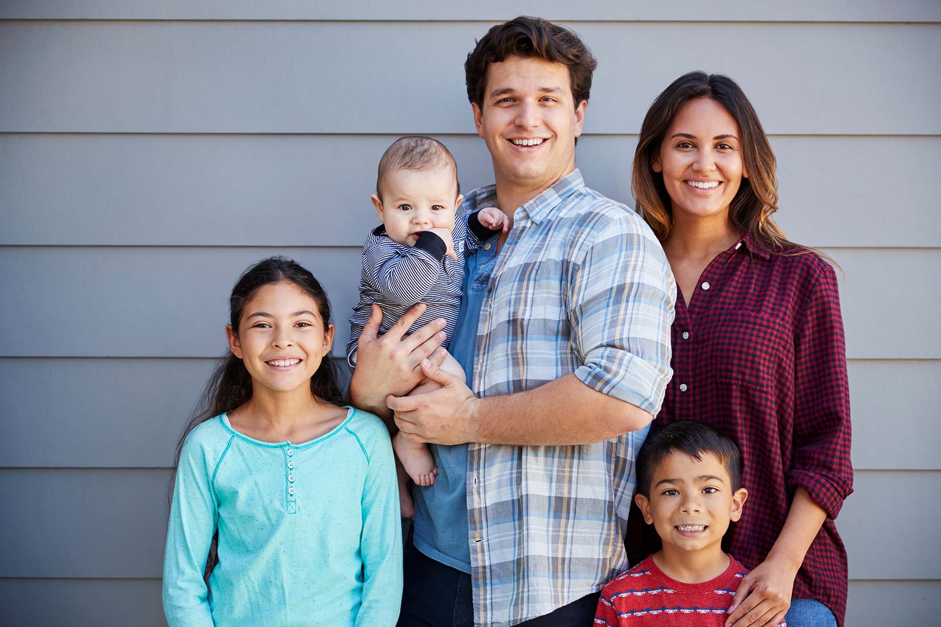 portrait of smiling family with 3 kids